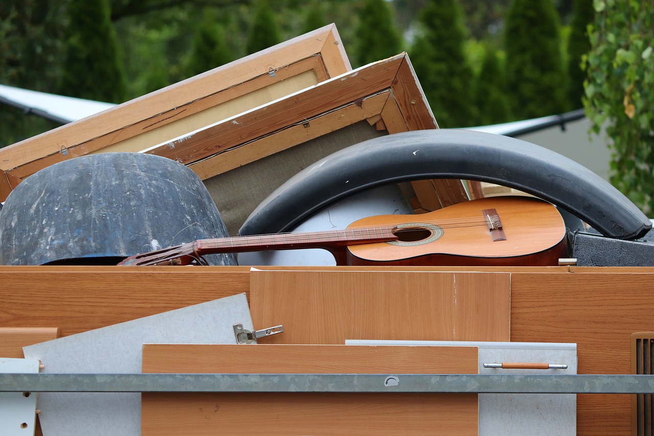 guitar and wooden boards in a big container at the tip.