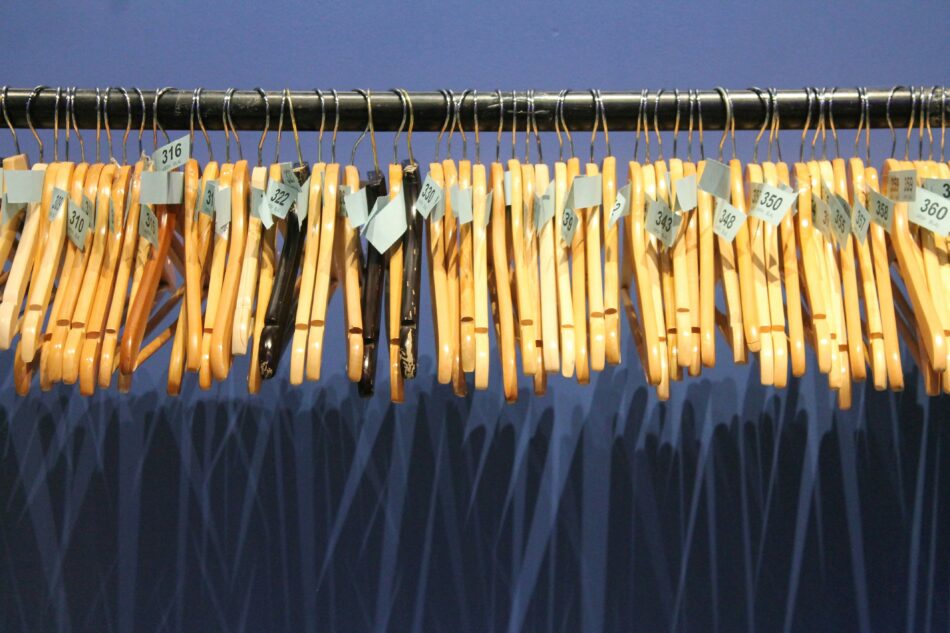 wooden coat hangers on a rack.