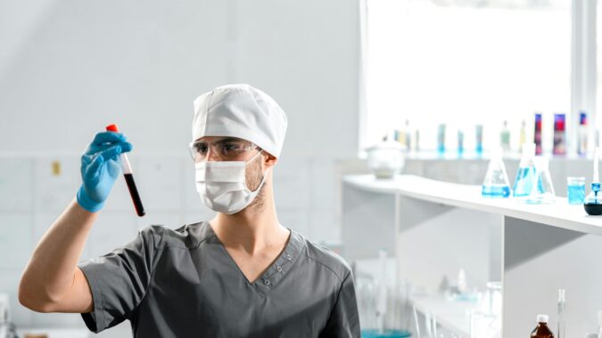 man with blood in a test tube.