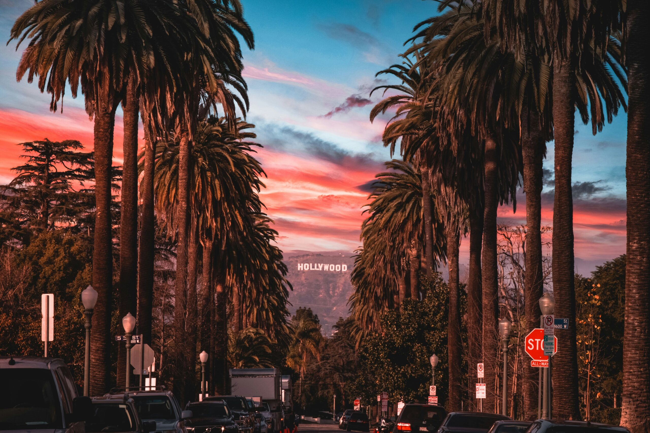 Hollywood sign between palm trees in LA.