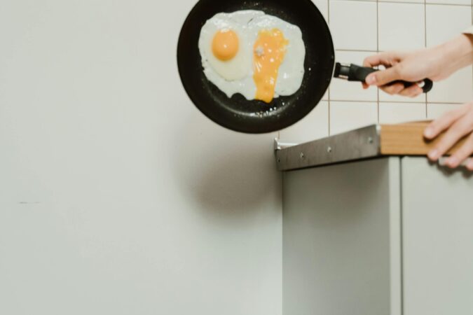egg being tipped into food waste bin