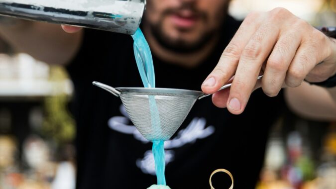 Bartender making a blue cocktail
